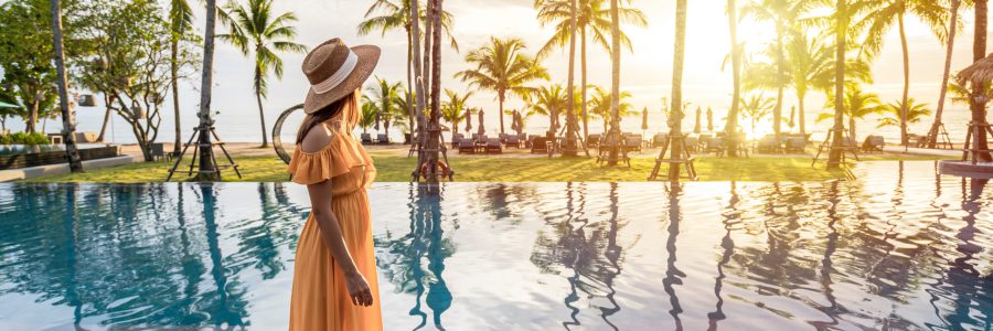 Woman enjoying a luxurious pool at a tropical hotel resort
